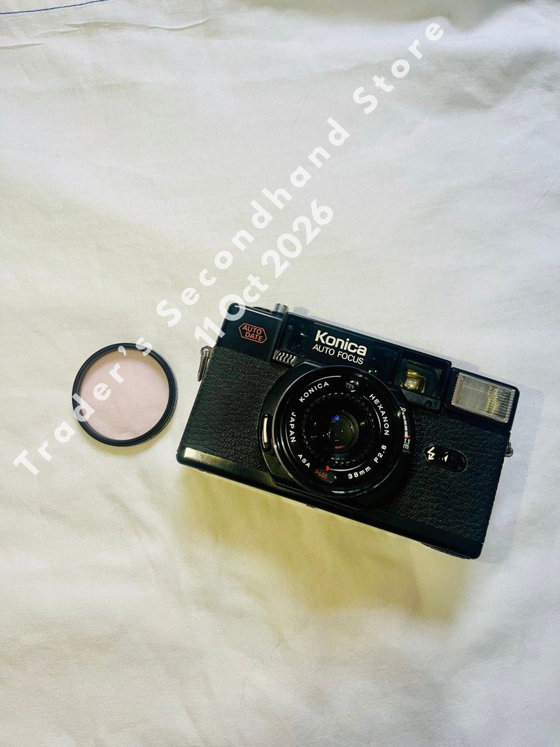 Konica C35 AF2 D Auto Date Film Camera (Category: Cameras) located in Manila. Submitted by traders_2ndhand (Listing ID 1467209799, Image 1). Description: - Model: Konica C35 AF2 D (Black body) - Lens: Built-in Konica Hexanon 38mm f/2.8 - Features: Auto date back, compact point-and-shoot rangefinder style - Format: Uses standard 35mm film - Inclusions: Kenko MC Skylight filter - Condition: Tested and working, working flash and shutter - No test ph