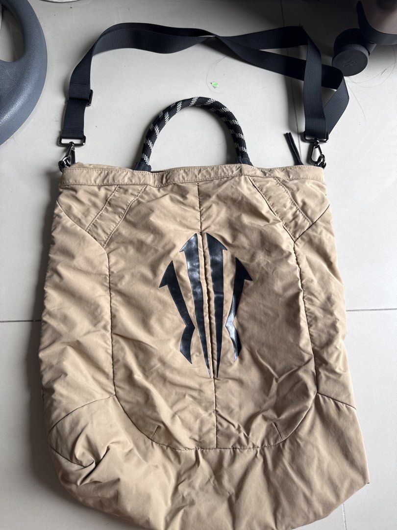 Kyrie bag (Category: Tote Bags) located in Manila. Submitted by hiiipurple (Listing ID 1467213570, Image 2). Description: - Color: Khaki with a distinct black graphic print - Material: Sturdy quilted fabric panels with reinforced stitching - Straps: Woven rope top handles and an adjustable black shoulder strap with swivel hooks - Compartment: Spacious interior, perfect for your daily essentials - Condition: Brand new and ready to ship!.