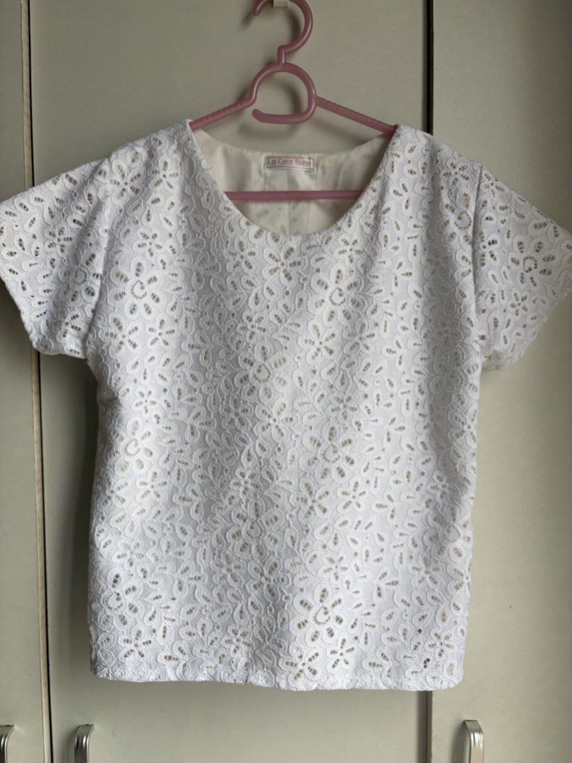 La Coco Babe White Lace Short Sleeve Blouse (Category: Blouses) located in Manila. Submitted by mgsib56360 (Listing ID 1467219970, Image 1). Description: - Brand: La Coco Babe - Free-size (please see photos for actual measurements) - Style: White lace short sleeve top with round neckline - Details: All-over floral lace pattern with inner lining - RFS: Moving out decluttering.