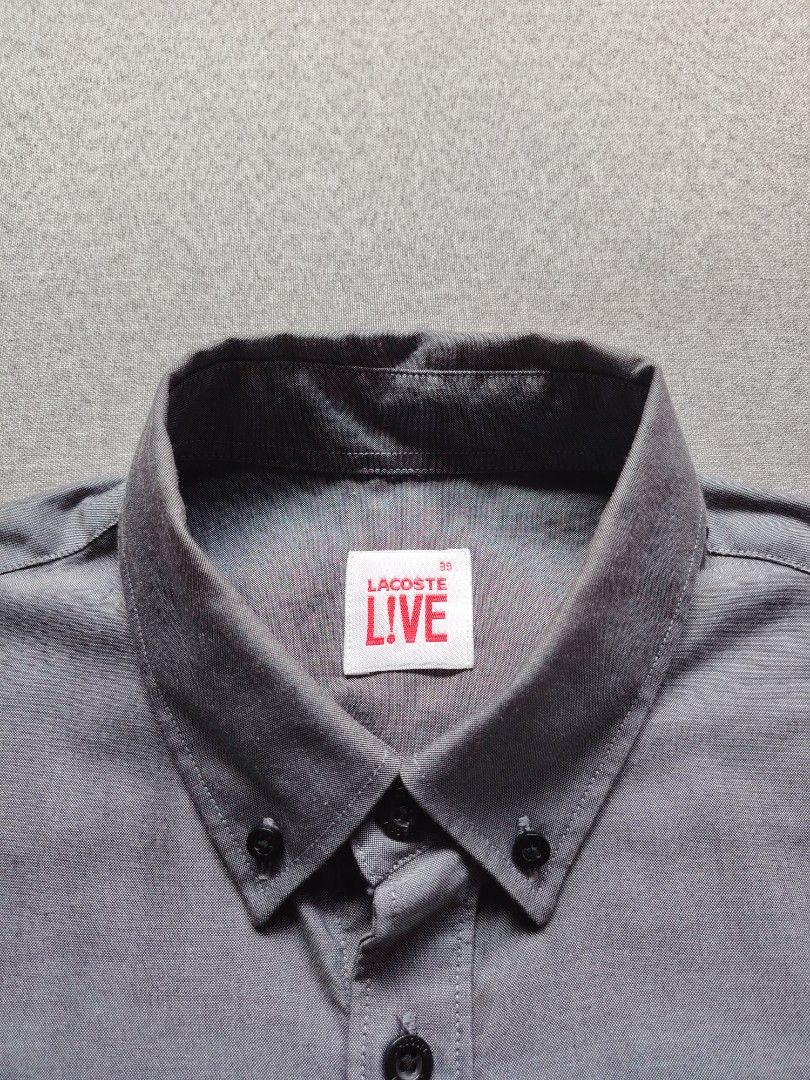 Lacost Live Button Down (Category: Tshirts & Polo Shirts ) located in Taguig. Submitted by _theroom.ph (Listing ID 1467198968, Image 2). Description: - Brand: Lacoste Live - Style: Short sleeve button-down shirt with collar - Color: Gray - Size: 39 (165/84A) - Material: 100% cotton - Details: Branded dark buttons and embroidered crocodile logo on chest - Condition: Clean inside and out, excellent pre-owned condition - Origin: Designed in France L