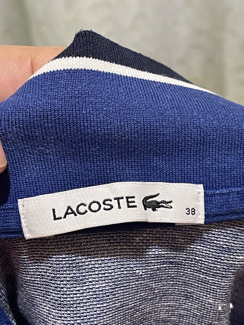 Lacoste Blue Polo Shirt Size 38 (Category: Shirts) located in Iligan City. Submitted by goldielooks143 (Listing ID 1467314450, Image 2). Description: - Brand: Lacoste - Style: Blue marled polo shirt with contrast collar and striped cuffs - Size: 38 (fits like S/M) - Details: Three-button placket with branded buttons, iconic embroidered green crocodile logo on the chest - Material: Premium cotton, modal, and polyester blend for all-day comfort - a