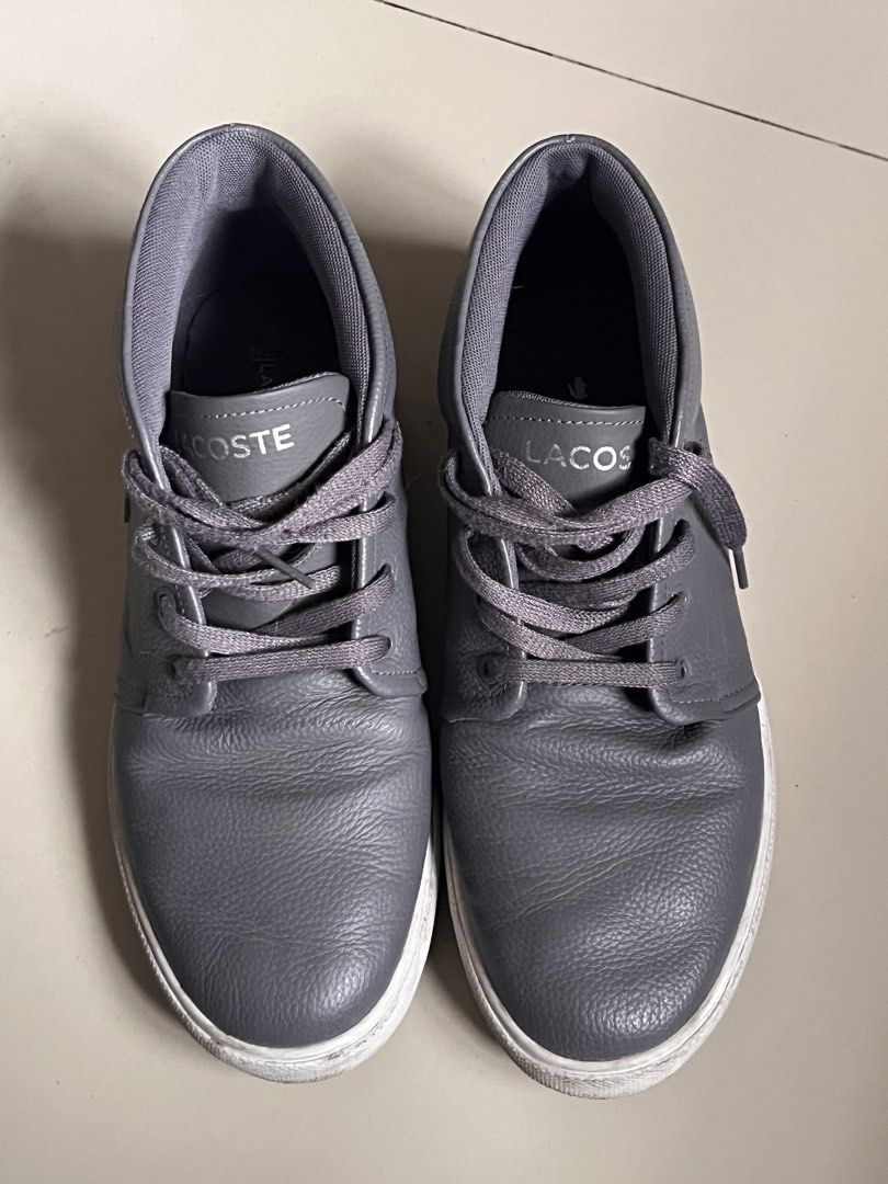 Lacoste Grey Leather Sneakers Mid Top (Category: Sneakers) located in Manila. Submitted by vandetoria (Listing ID 1467199216, Image 1). Description: - Brand: Lacoste - Style: Grey leather mid-top sneakers - Soles: White rubber with light dirt marks - Material: Soft tumbled leather upper - Details: Matching grey laces, padded ankle collar, silver tongue branding - Condition: Minor toe creasing from normal wear, clean interior lining - Best for: So