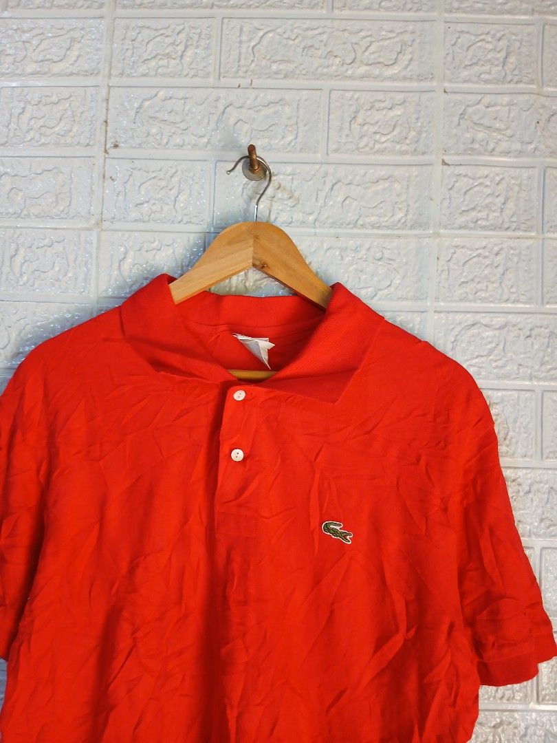 Lacoste Red Polo Shirt Size 6 (Category: Tshirts & Polo Shirts ) located in Davao. Submitted by marissasof29286 (Listing ID 1467361228, Image 2). Description: - Brand: Lacoste - Color: Bright red - Size: 6 - Material: 100% cotton - Origin: Made in Peru - Design: Classic two-button collar with embroidered green crocodile logo and standard short sleeve cut - Condition: Wrinkled from storage, needs ironing.