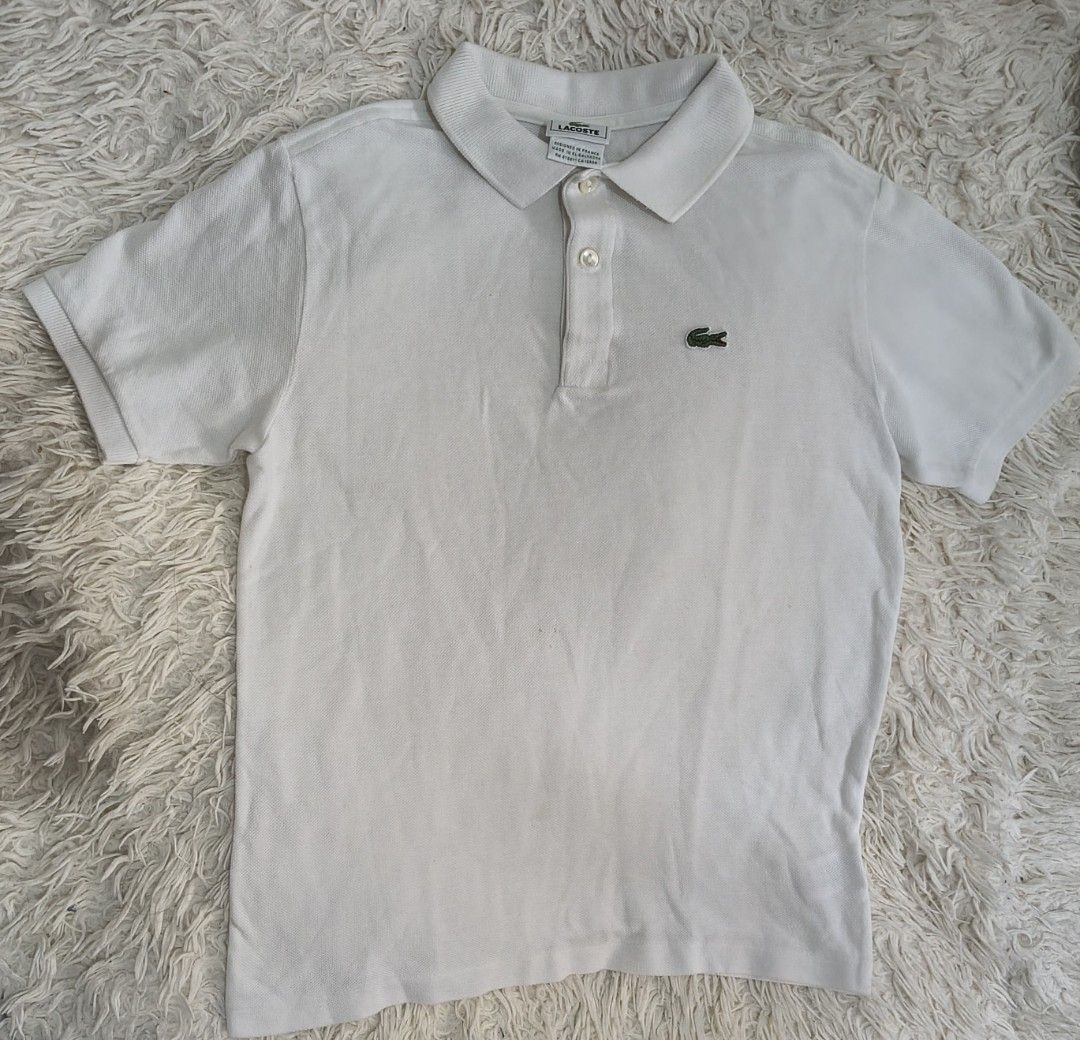 Lacoste White Polo Shirt (Category: Tshirts & Polo Shirts ) located in Tanza. Submitted by mharicor1589643 (Listing ID 1467331735, Image 2). Description: - Authentic White Lacoste Polo Shirt - Premium piqué cotton fabric for comfort - Classic collar with a 2-button placket and pearlescent buttons - Iconic embroidered green crocodile logo on the chest - Clean collar and cuffs - Made in El Salvador - Condition: Excellent / Pre-loved.