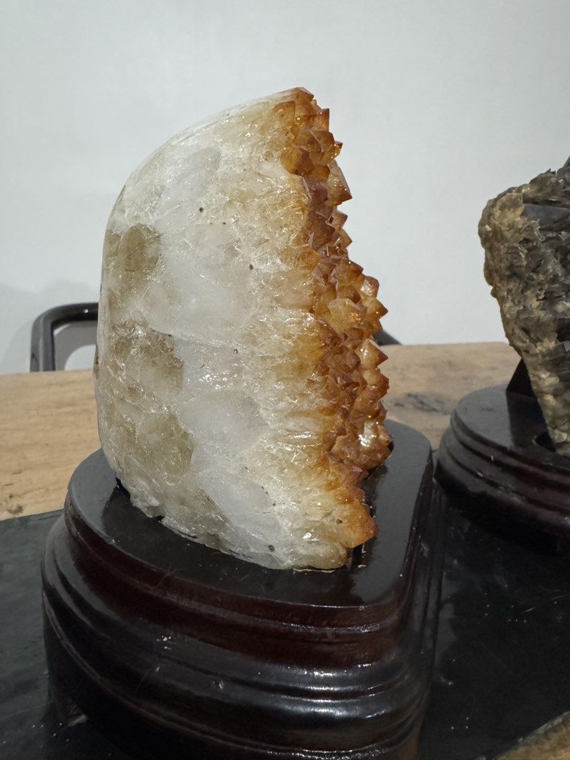 Large Citrine Crystal Cluster Geode on Wooden Base (Category: Precious Stones) located in Manila. Submitted by sofiageorgia_1998 (Listing ID 1467178699, Image 2). Description: - Genuine natural citrine crystal cluster with rich golden-amber points - Features a sturdy white quartz matrix backing -Abundance stone - Includes a dark polished wooden display stand for upright stability - Stunning deep orange-yellow color gradient across the front face 