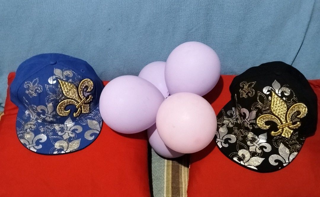 Leader In Headwear Fleur-De-Lis Snapback Caps (Category: Caps & Hats) located in Manila. Submitted by bethistama04142 (Listing ID 1467280577, Image 1). Description: - Brand: Leader In Headwear - Quantity: 2 caps (1 Blue, 1 Black) - Design: Metallic silver fleur-de-lis pattern with raised gold embroidered fleur-de-lis patch - Size: Size M fitted hats - Condition: Brand new, unworn with original holographic authenticity stickers and interior brandi