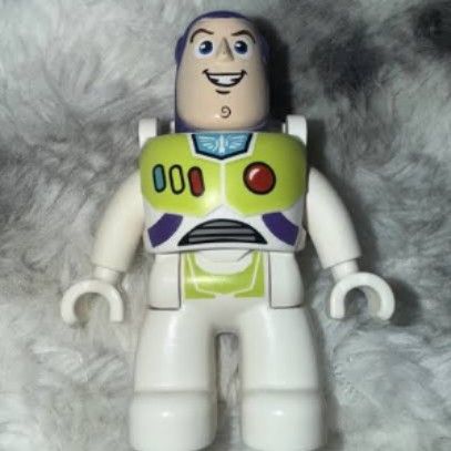 LEGO DUPLO Buzz Lightyear figure (Category: Lego & Building Sets) located in Tarlac. Submitted by kio-kun (Listing ID 1467263967, Image 2). Description: LEGO DUPLO Buzz Lightyear figure • Character: Buzz Lightyear • Brand: LEGO DUPLO 🔥 • Features: Purple hood, white and green space suit, chest control panel with red, green, and blue buttons, and a white rear wing/jetpack assembly. • Releases: Originally appeared around 2010 in sets like The Grea