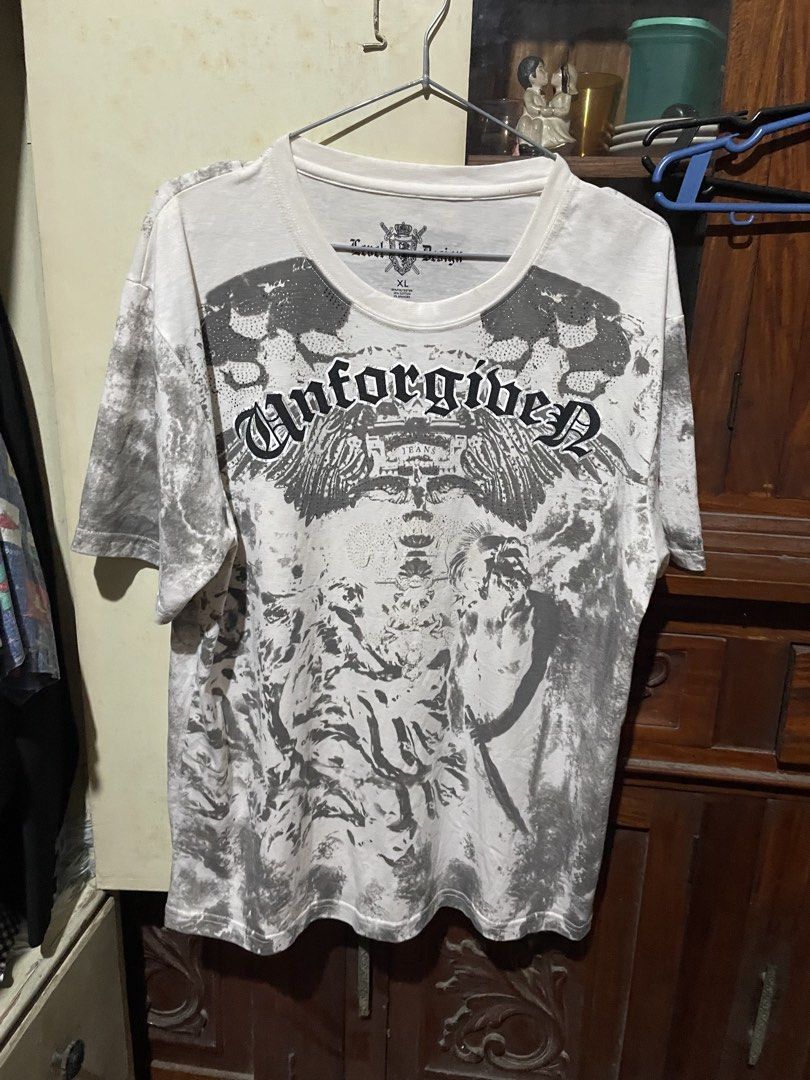Level Design Unforgiven Graphic Tee Shirt XL (Category: Tshirts & Polo Shirts ) located in Valenzuela. Submitted by mikayruu (Listing ID 1467311050, Image 1). Description: - Size: XL - Color/Pattern: White and grey tie-dye - Design: Heavy graphic prints on front and back with 'Unforgiven' lettering and 'Level Design' logo - Fit: Short sleeves, crew neck - Material: 65% polyester, 30% cotton, 5% spandex - Care Instructions: Hand wash only.
