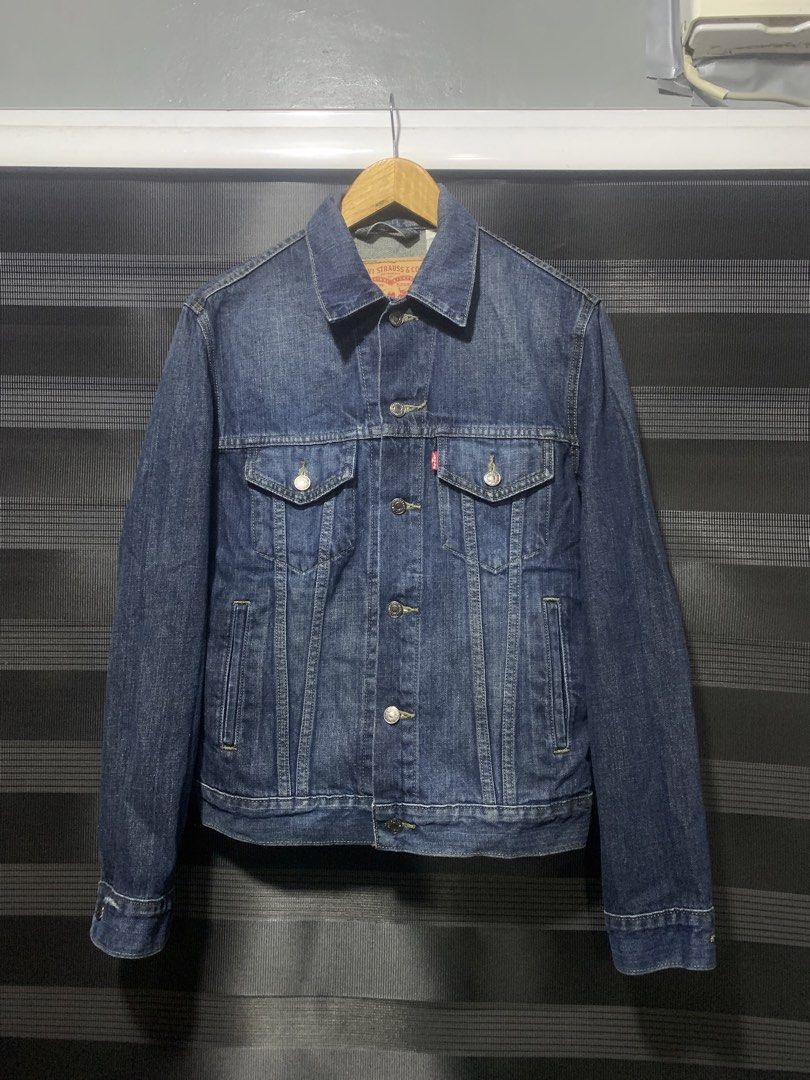Levi Strauss & Co. Denim Jacket (Category: Coats, Jackets and Outerwear) located in Antipolo. Submitted by RAREFINDS (Listing ID 1467332282, Image 1). Description: - Brand: Levi Strauss & Co. - Style: Classic denim trucker jacket - Color: Dark wash blue - Details: Branded metallic buttons, red tab logo, two-horse leather patch - Pockets: Chest flap pockets and side welt pockets - Origin: Made in Colombia - Condition: Clean, excellent, and ready t