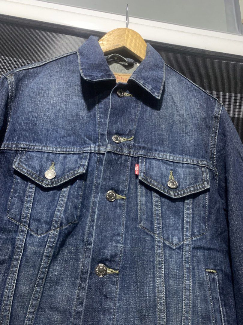 Levi Strauss & Co. Denim Jacket (Category: Coats, Jackets and Outerwear) located in Antipolo. Submitted by RAREFINDS (Listing ID 1467332282, Image 3). Description: - Brand: Levi Strauss & Co. - Style: Classic denim trucker jacket - Color: Dark wash blue - Details: Branded metallic buttons, red tab logo, two-horse leather patch - Pockets: Chest flap pockets and side welt pockets - Origin: Made in Colombia - Condition: Clean, excellent, and ready t