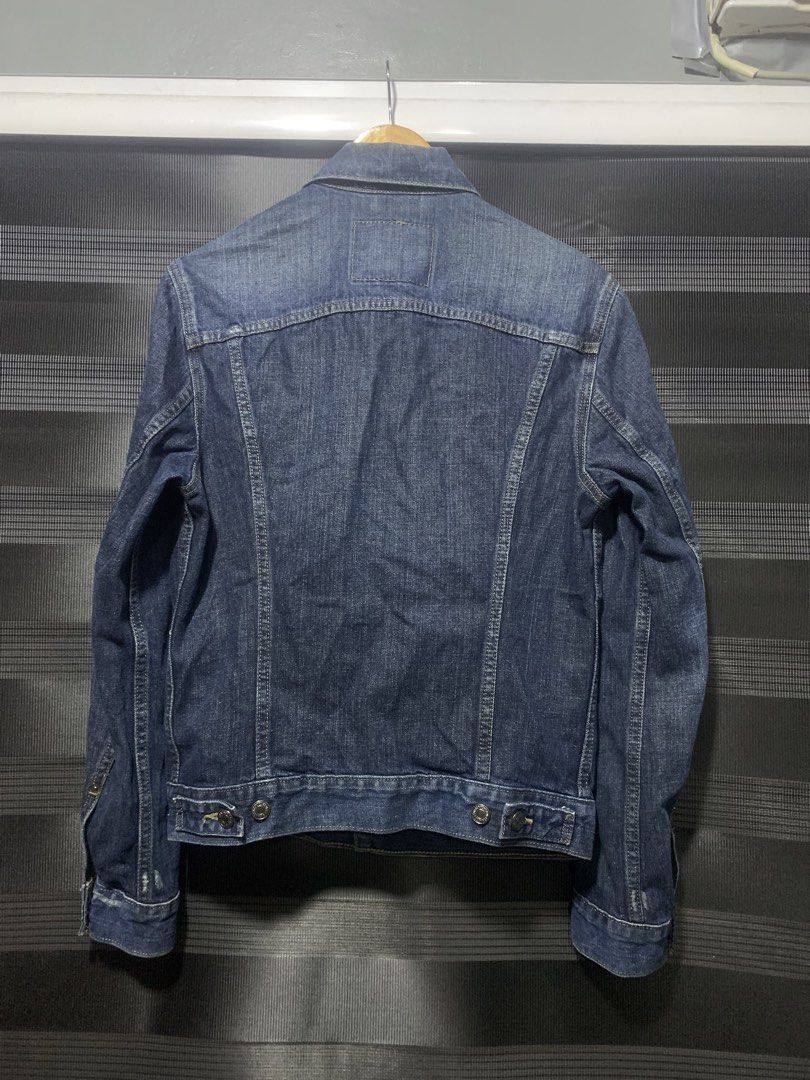 Levi Strauss & Co. Denim Jacket (Category: Coats, Jackets and Outerwear) located in Antipolo. Submitted by RAREFINDS (Listing ID 1467332282, Image 2). Description: - Brand: Levi Strauss & Co. - Style: Classic denim trucker jacket - Color: Dark wash blue - Details: Branded metallic buttons, red tab logo, two-horse leather patch - Pockets: Chest flap pockets and side welt pockets - Origin: Made in Colombia - Condition: Clean, excellent, and ready t