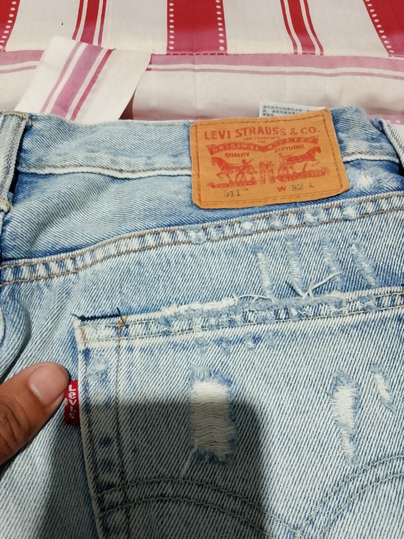Levi's 511 Patchwork Denim Shorts Size 32 (Category: Shorts) located in Iloilo. Submitted by janillthrifted (Listing ID 1467332859, Image 2). Description: Levi's 511 denim shorts with distressed details and colorful patchwork panels on the front and back. Size 32 waist. Button fly, classic five-pocket styling, and branded leather back patch. Unique custom look..