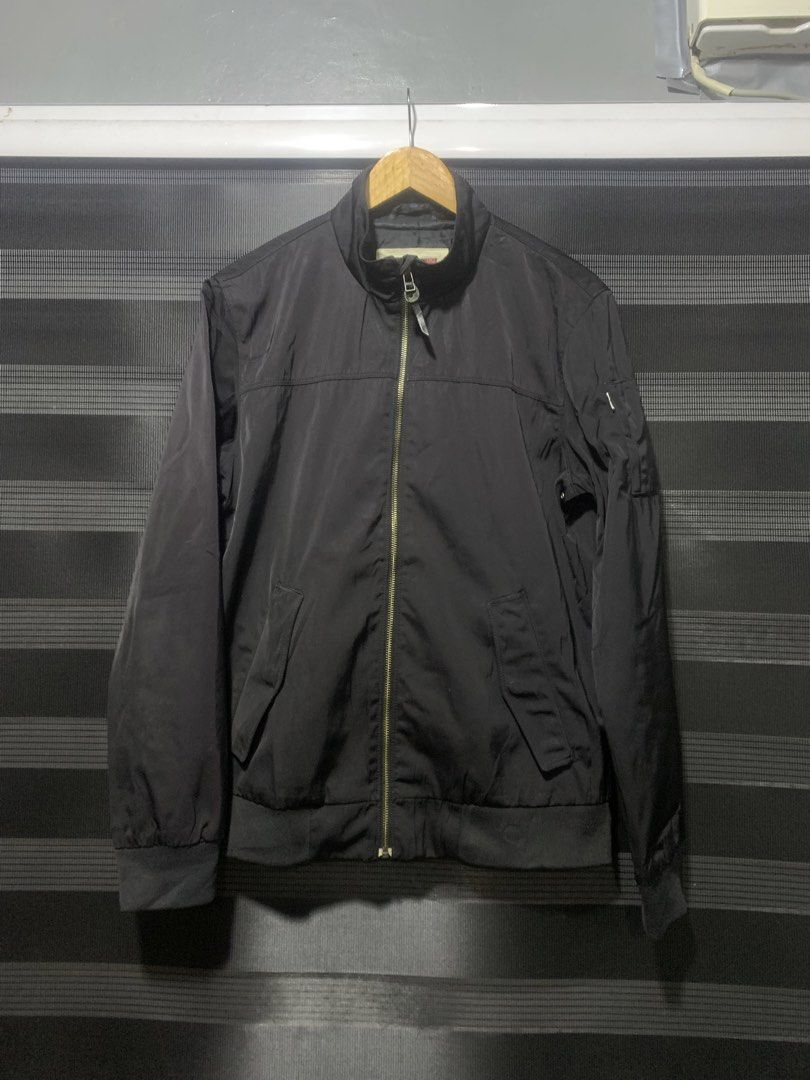Levi's Black Bomber Jacket Size M (Category: Coats, Jackets and Outerwear) located in Antipolo. Submitted by RAREFINDS (Listing ID 1467328783, Image 1). Description: - Brand: Levi's - Style: Black bomber jacket - Size: Medium - Closure: Full zip front with high collar - Features: Utility pocket on the left sleeve, ribbed cuffs and hem - Material: 100% polyester (Made in Bangladesh) - Condition/Vibe: Classic everyday outerwear, super easy to match