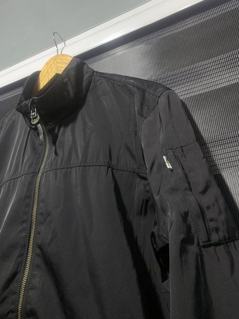 Levi's Black Bomber Jacket Size M (Category: Coats, Jackets and Outerwear) located in Antipolo. Submitted by RAREFINDS (Listing ID 1467328783, Image 2). Description: - Brand: Levi's - Style: Black bomber jacket - Size: Medium - Closure: Full zip front with high collar - Features: Utility pocket on the left sleeve, ribbed cuffs and hem - Material: 100% polyester (Made in Bangladesh) - Condition/Vibe: Classic everyday outerwear, super easy to match