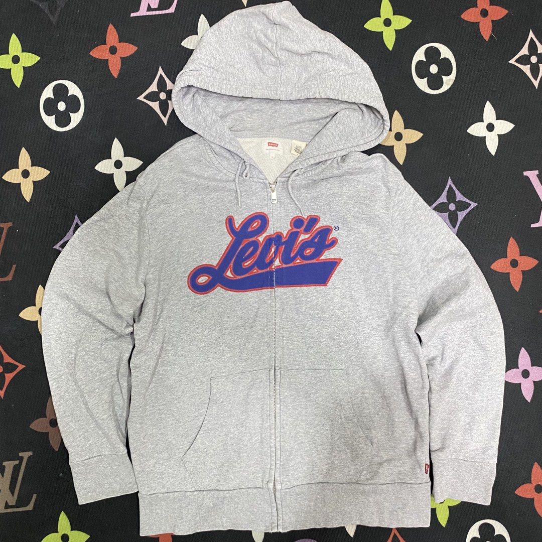 Levi's Grey Zip-Up Hoodie with Script Logo (Category: Hoodies) located in Loreto, Surigao del Norte. Submitted by ongcollection_747 (Listing ID 1467329958, Image 1). Description: - Brand: Levi's - Item: Zip-up hoodie - Size: Medium - Color: Grey with red and blue script logo - Features: Full zipper front, adjustable hood drawstrings, front kangaroo pockets, and classic red tab on the cuff - Condition: Clean fleece material inside and out.