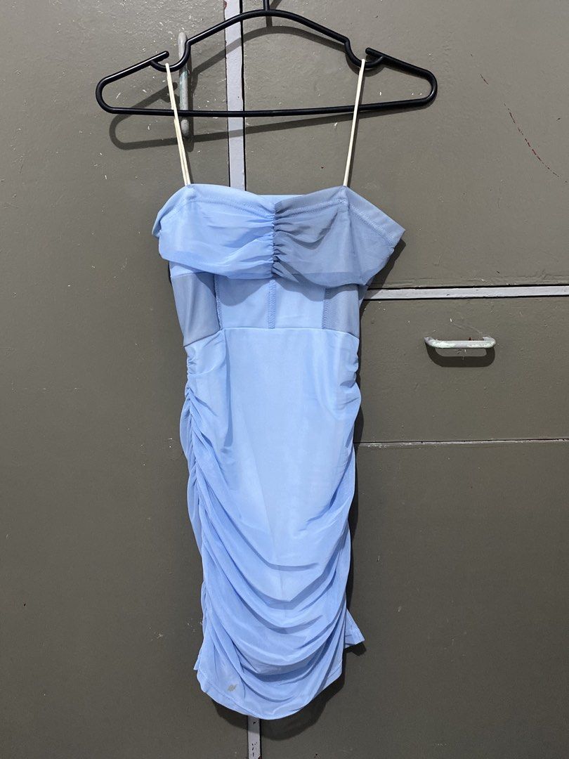 Light blue ruched spaghetti strap bodycon mini dress (Category: Dresses) located in Manila. Submitted by e071803 (Listing ID 1467250046, Image 1). Description: - Color: Baby blue - Style: Ruched mini dress with thin straps - Fit: Body-hugging with super stretchy mesh fabric - Details: Gathered ruched detailing on the bust - Condition: Good, but has a small dark stain near the bottom front hem (see 2nd photo) - Perfect for: Casual outings or parti