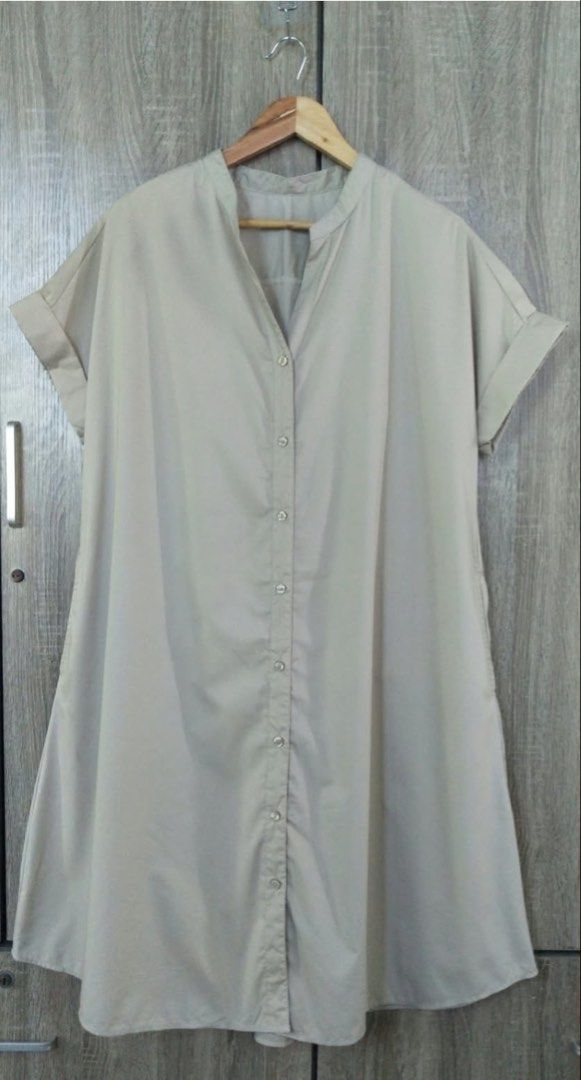Light Grey Button-Up Shirt Dress with Pockets (Category: Dresses) located in Goa. Submitted by quicktree_baby (Listing ID 1467244249, Image 2). Description: - Color: Light grey - Style: Knee-length shirt dress with mandarin collar and short cuffed sleeves - Closure: Full button placket down the front - Features: Practical side pockets - Fabric: Smooth and comfortable - Perfect for: Everyday wear or casual work outfits.