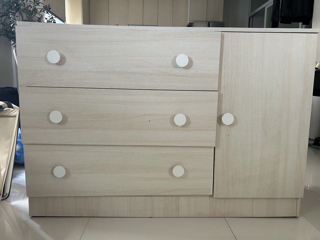 Light Wood Grain Storage Cabinet with Drawers (Category: Shelves, Cabinets & Racks) located in Bacoor. Submitted by maytime (Listing ID 1467239544, Image 1). Description: - Light wood grain finish matches any room decor - 3 wide pull-out drawers on the left with cute white knobs - Tall right-side cabinet includes a built-in hanging rail - Sturdy construction with clean, modern lines - Pick up only.