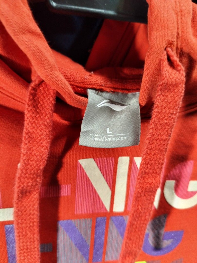 Li-Ning Red Hoodie Size L (Category: Coats, Jackets and Outerwear) located in Manila. Submitted by tawnycollectiblesshop (Listing ID 1467217169, Image 3). Description: - Brand: Li-Ning - Color: Bright Red - Size: Large - Style: Pullover with adjustable drawstring hood - Design: Multi-colored stacked Li-Ning typography graphic on chest - Features: Front kangaroo pocket, ribbed cuffs and hem to lock in warmth - Condition/Material: Soft and comforta