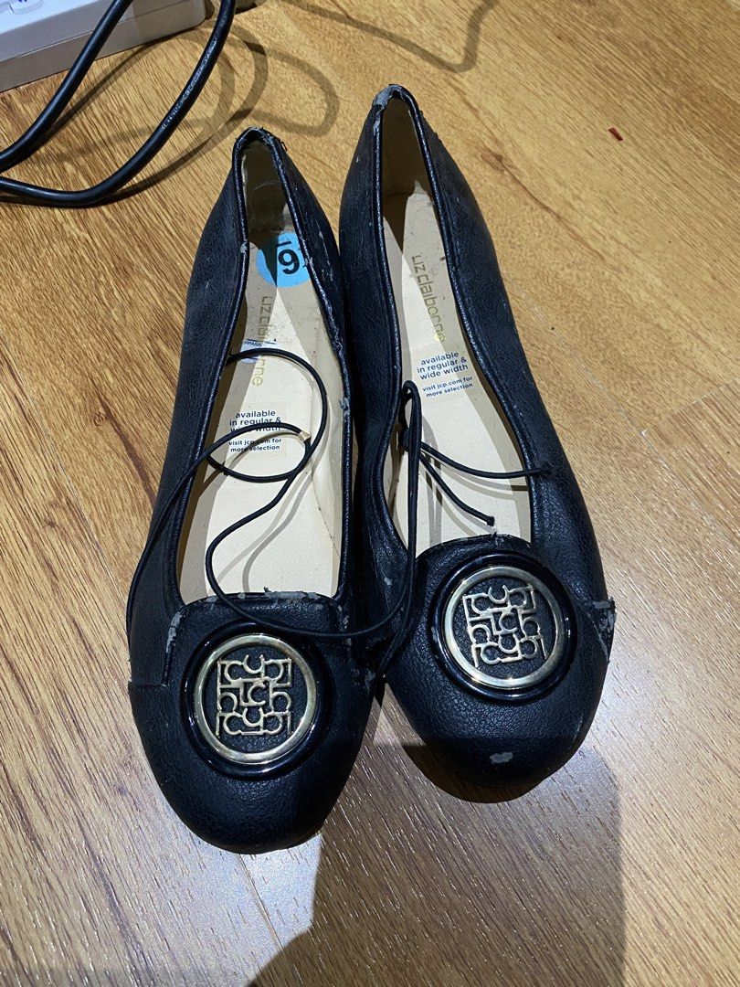 Liz Claiborne Black Ballet Flats (Category: Flats & Sandals) located in Manila. Submitted by mpt99876 (Listing ID 1467349808, Image 1). Description: - Brand: Liz Claiborne - Size: US 6 - Color: Classic black with gold hardware logo medallion - Design: Slip-on ballet flats with thin decorative top laces - Condition: Pre-loved with visible wear, tread marks, scuffs, and PU leather peeling (especially around the toe caps and edges) - Perfect for cas