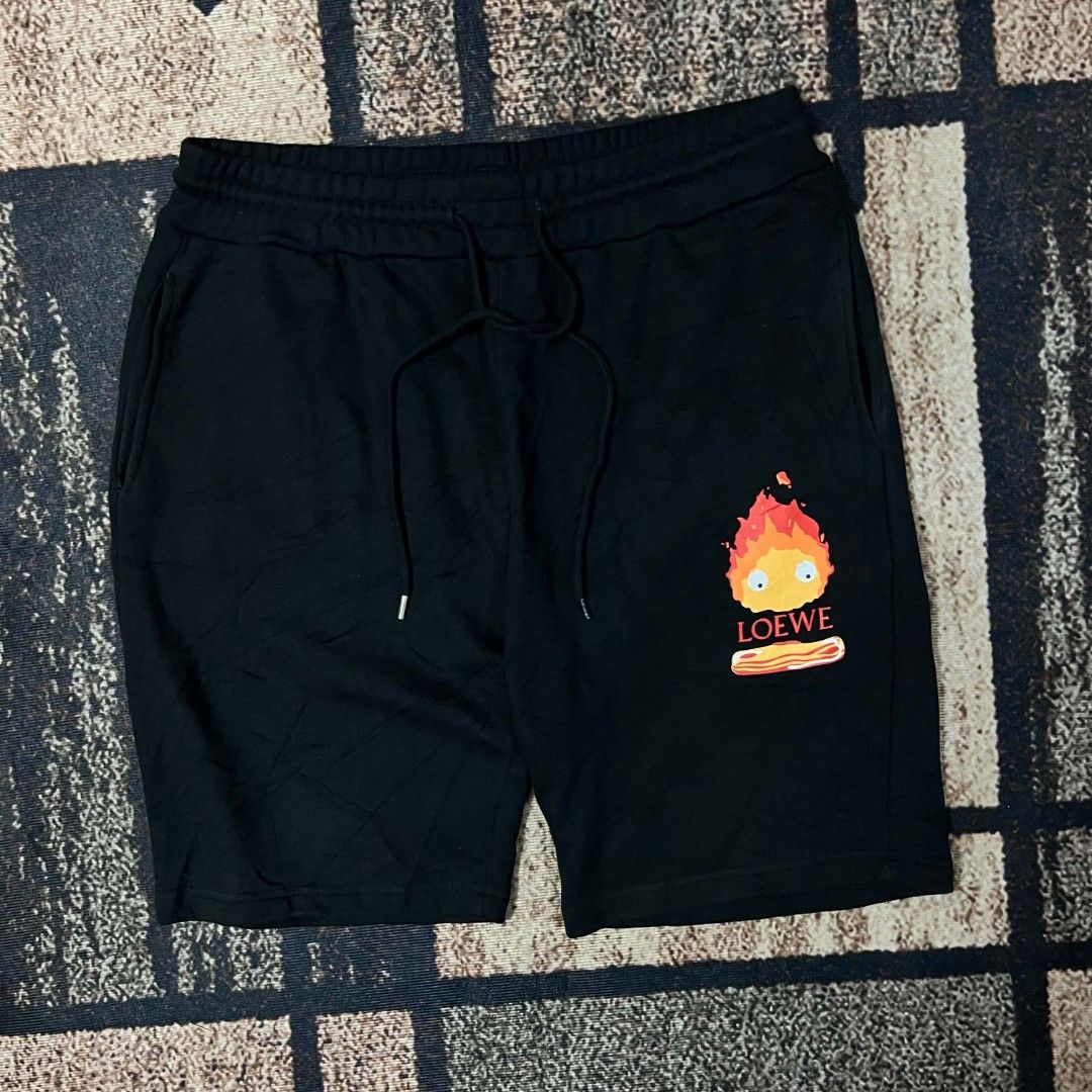 Loewe Calcifer Sweatshorts Black (Category: Shorts) located in Cebu City. Submitted by royalwolf-2a85 (Listing ID 1467308534, Image 2). Description: - Authentic Loewe x Calcifer sweatshorts in classic black - Features cute Calcifer and bacon graphic print with Loewe logo on the left leg - Made in Portugal with ultra-soft, premium cotton for all-day comfort - Adjustable drawstring waist for the perfect fit - Functional side pockets and one back po