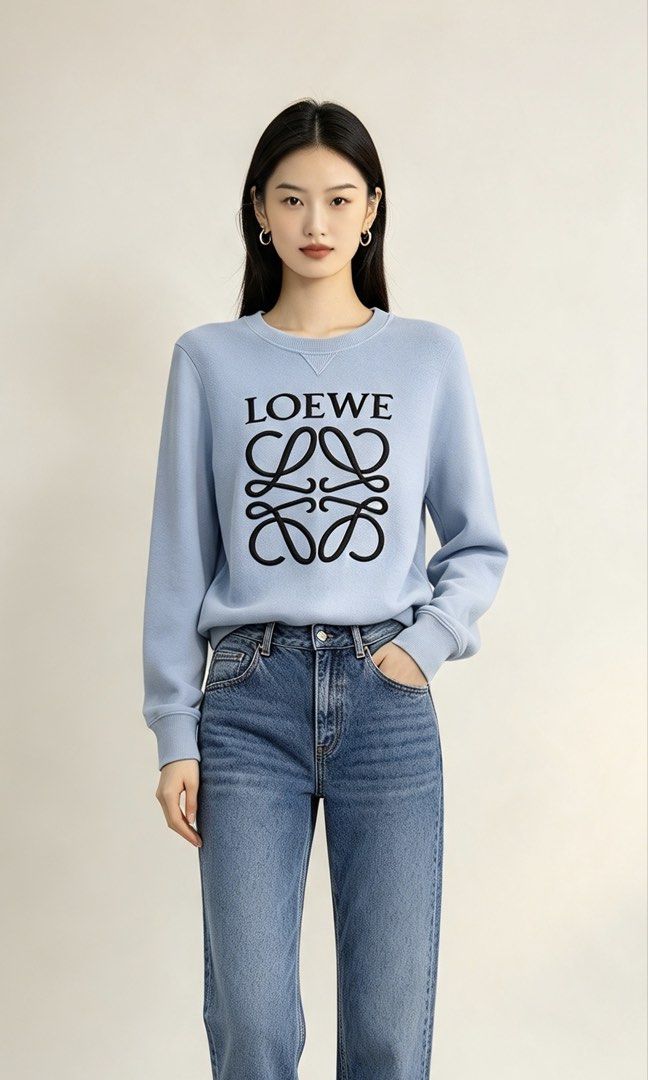 Loewe Light Blue Anagram Sweatshirt (Category: Luxury Apparel) located in Paranaque City. Submitted by mykapoynton (Listing ID 1467241653, Image 1). Description: Loewe Light Blue Anagram Sweatshirt - Style: Crewneck sweatshirt - Color: Light blue with black Anagram logo - Material: 100% cotton - Origin: Made in Portugal - Size: S - Condition/Details: Comfortable fit with ribbed collar, cuffs, and hem.