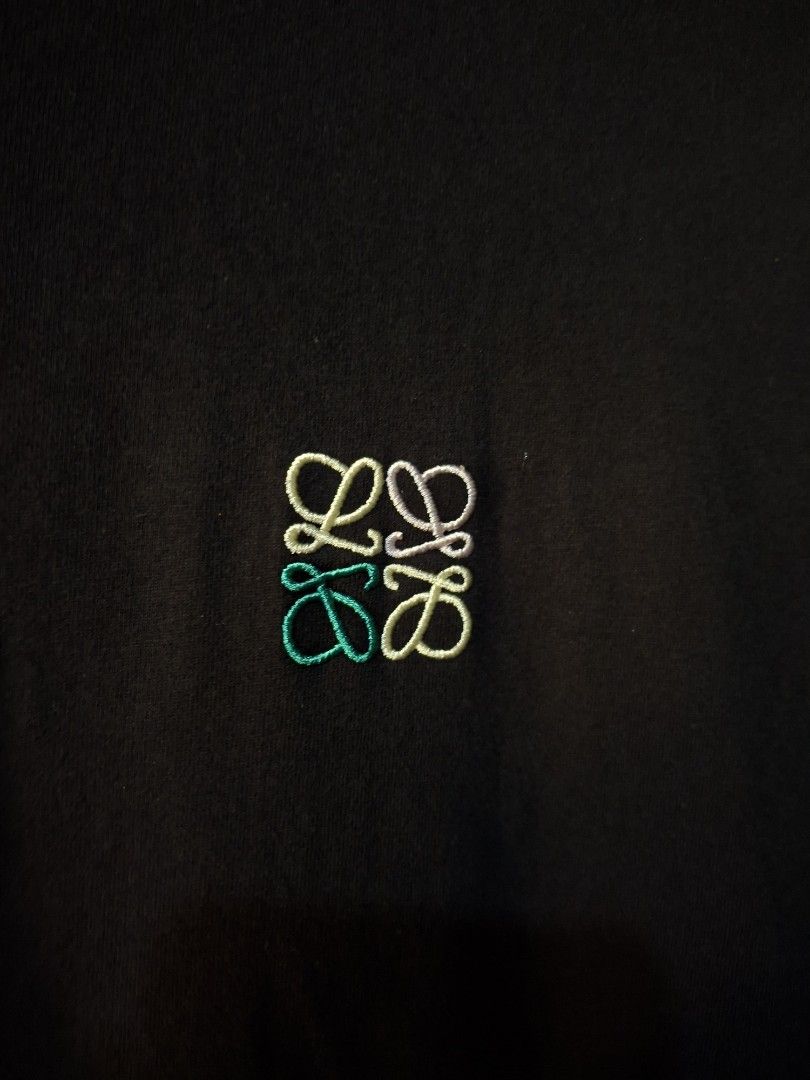 Loewe Multicolour Logo Embroidered (Category: Luxury Apparel) located in San Juan (Cabalian). Submitted by ec8thrift (Listing ID 1467185401, Image 2). Description: - Loewe Multicolour Logo Embroidered - Material: Premium Cotton - Design: Crew neck with regular short sleeves - Detail: Multicolored embroidered Loewe Anagram logo on the chest - Condition: Brand new with interior tag - Style: Versatile everyday essential - Shipping or meetups availab