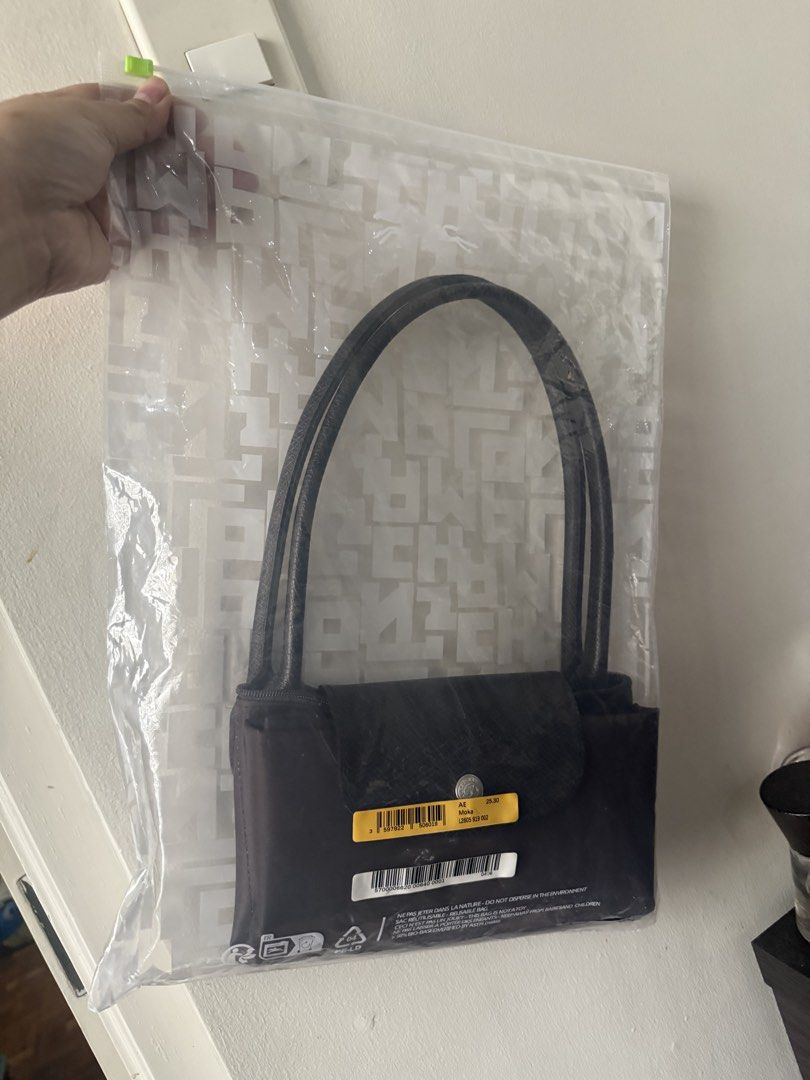 Longchamp Le Pliage Moka Brown Bag (Category: Luxury Bags & Wallets) located in Quezon City. Submitted by msaisa (Listing ID 1467184345, Image 3). Description: - Brand: Longchamp Le Pliage - Color: Moka (Brown) - Condition: Brand new with store tag, still inside original clear plastic packaging - Design: Compact size with double shoulder handles, top zip closure, and iconic front snap button flap - Style: Versatile and chic everyday shoulder bag.