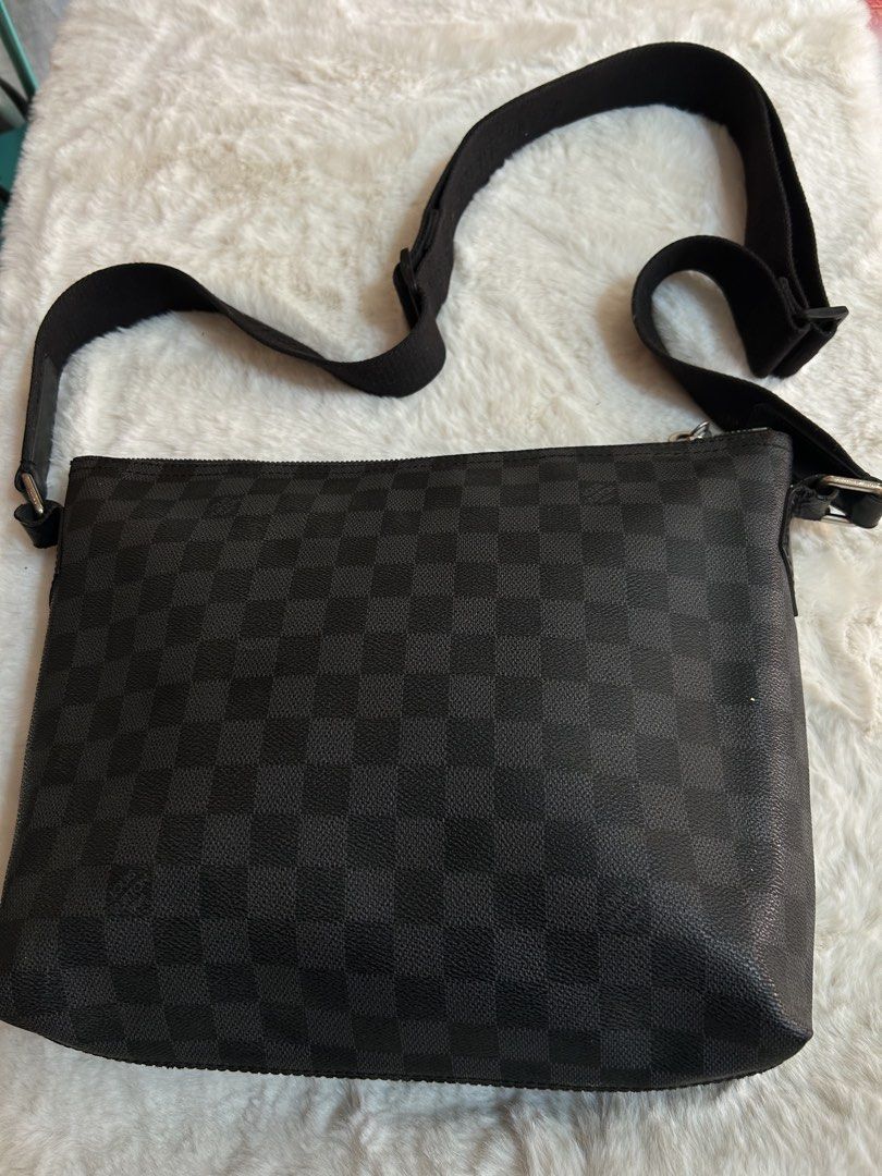 Louis Vuitton Damier Graphite Messenger Bag (Category: Luxury Bags & Wallets) located in Valencia. Submitted by carmzfindsph (Listing ID 1467265388, Image 2). Description: - Authentic Louis Vuitton messenger bag - Iconic Damier Graphite dark grey and black checkerboard canvas - Adjustable black fabric shoulder strap with sturdy metal hardware - Convenient front zippered pocket for quick access - Clean black textile interior with practical slip po