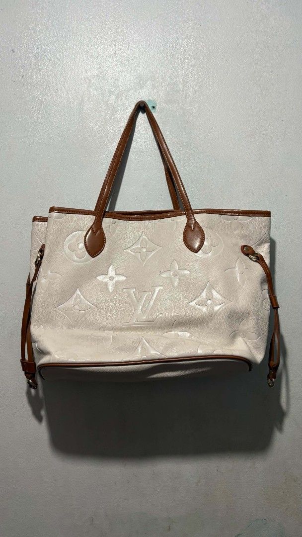 Louis Vuitton Monogram Empreinte Tote Bag (Category: Luxury Bags & Wallets) located in Manila. Submitted by alenoid (Listing ID 1467276699, Image 1). Description: - Brand: Louis Vuitton - Color: Cream with brown leather trim - Material: Debossed monogram pattern with gold-tone hardware - Interior: Striped fabric lining with a zipped pocket and patch logo - Closure: Top hook closure with side cinch straps - Features: Spacious everyday carryall, pe