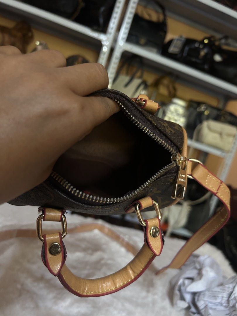 Louis Vuitton Monogram Nano Speedy Barrel Bag (Category: Luxury Bags & Wallets) located in Valencia. Submitted by carmzfindsph (Listing ID 1467181007, Image 3). Description: - Louis Vuitton mini barrel bag in iconic monogram canvas - Features chic tan leather trim and shiny gold-tone hardware - Secure top zip closure with a spacious dark fabric-lined interior - Comes with twin top handles and a long shoulder strap - Condition note: Minor peeling 