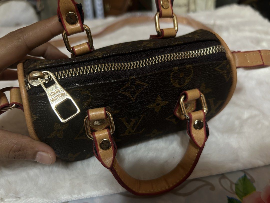 Louis Vuitton Monogram Nano Speedy Barrel Bag (Category: Luxury Bags & Wallets) located in Valencia. Submitted by carmzfindsph (Listing ID 1467181007, Image 2). Description: - Louis Vuitton mini barrel bag in iconic monogram canvas - Features chic tan leather trim and shiny gold-tone hardware - Secure top zip closure with a spacious dark fabric-lined interior - Comes with twin top handles and a long shoulder strap - Condition note: Minor peeling 