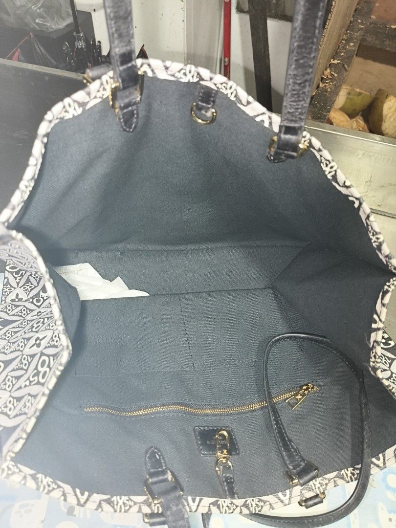 Louis Vuitton Monogram Tote Bag Black White (Category: Luxury Bags & Wallets) located in Quezon City. Submitted by anitagalan89774 (Listing ID 1467180255, Image 2). Description: - Material: Black and white monogram jacquard canvas with dark leather trim - Straps: Comfortable dark leather shoulder straps and matching top handles - Interior: Roomy fabric lining featuring a secure zip pocket and handy slip pockets - Hardware: Elegant gold-tone hardw