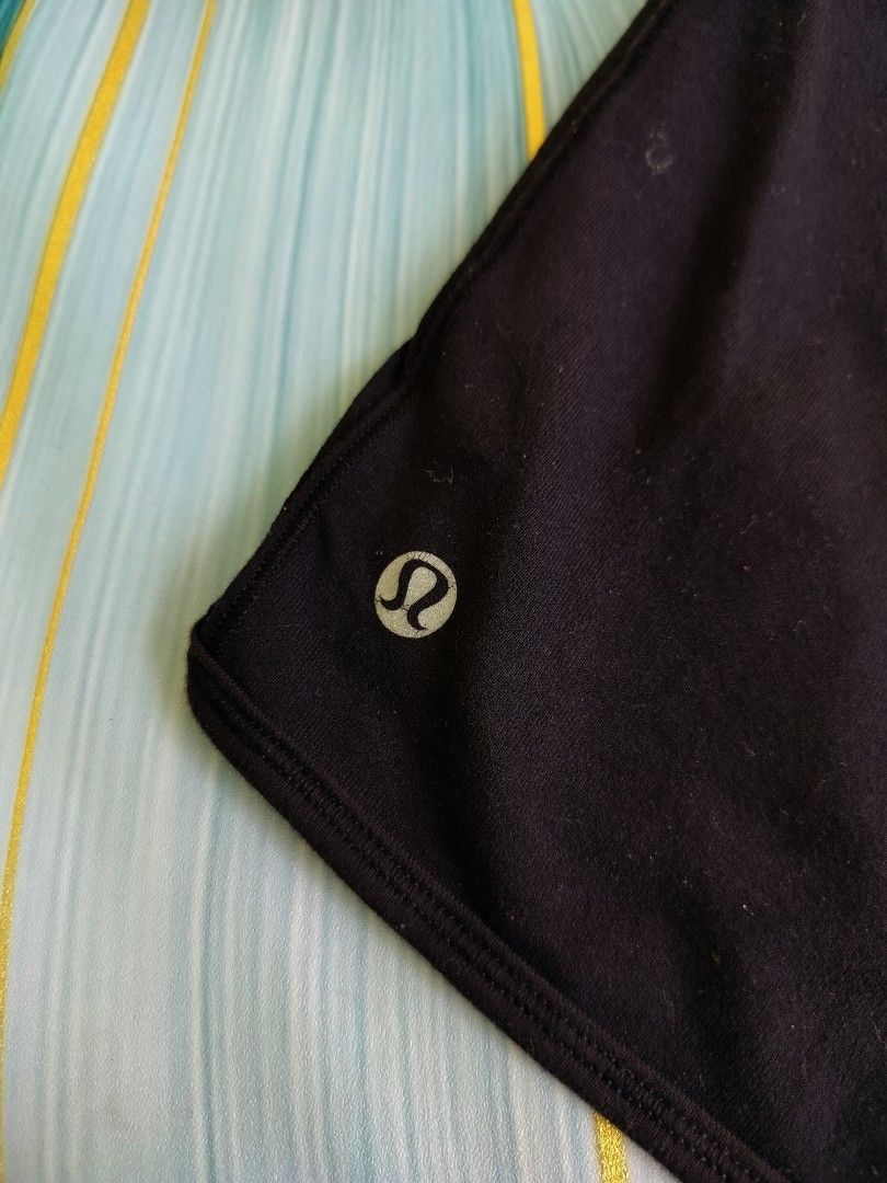 Lululemon Black Athletic Shorts Size 4 (Category: Shorts) located in Manila. Submitted by virgiliosa38485 (Listing ID 1467291741, Image 2). Description: - Brand: Lululemon - Size: 4 (verified via interior size dot) - Color: Classic Black - Design: Trendy crossover waistband with signature silver omega logos - Material: Comfortable, high-stretch athletic fabric.