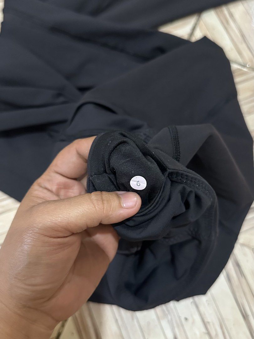 Lululemon Black Leggings Size 6 (Category: Activewear) located in Angeles City. Submitted by alejeong27 (Listing ID 1467267825, Image 3). Description: - Brand: Lululemon - Color: Classic Black - Size: 6 (tag attached) - Features: Structured contour seams for a flattering fit, comfortable waistband, and signature silver reflective omega logo on the back hip - Fabric: Soft, high-stretch athletic material for maximum comfort - Condition: Excellent p