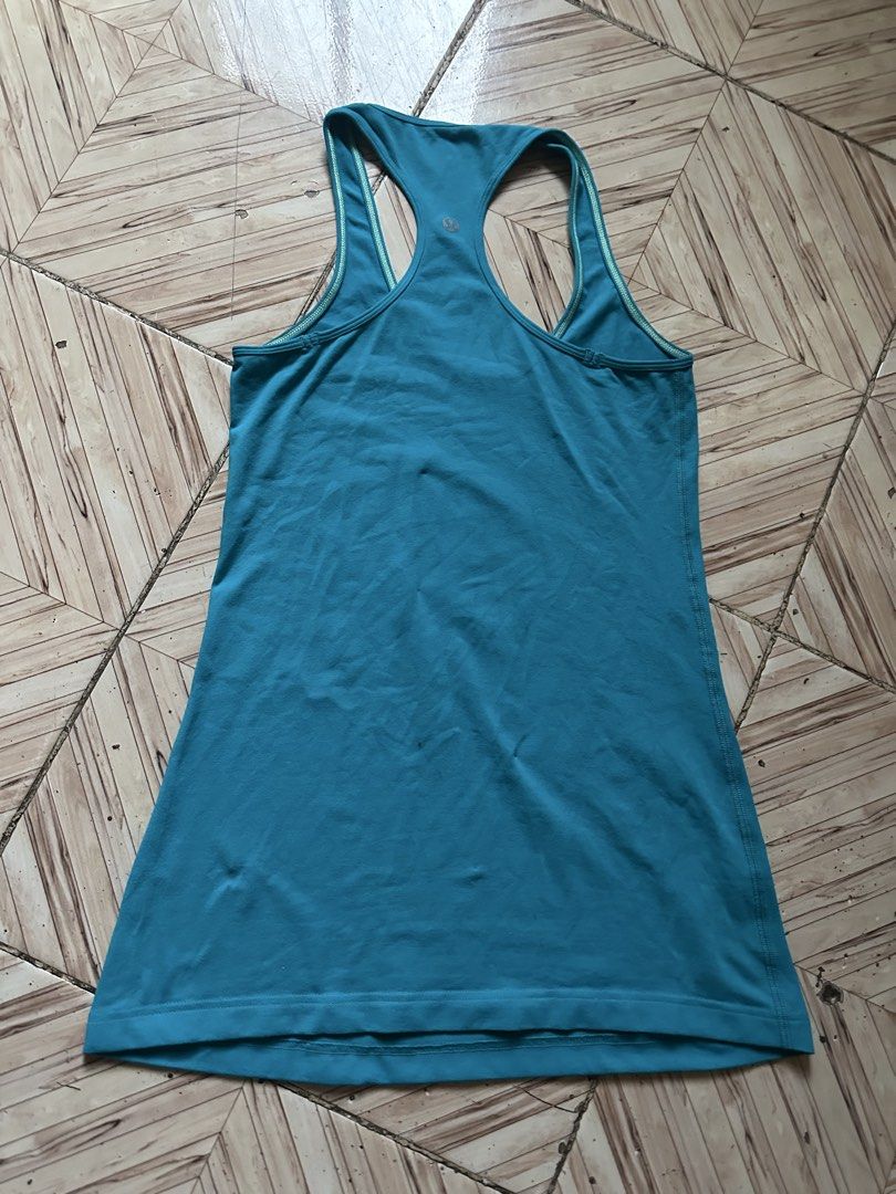 Lululemon Blue Racerback Tank Top (Category: Activewear) located in Angeles City. Submitted by alejeong27 (Listing ID 1467262184, Image 2). Description: - Authentic Lululemon athletic tank top in a vibrant bright blue shade - Stylish racerback design featuring contrast trim along the neckline and armholes - Signature reflective silver omega logo on the upper back strap - Buttery soft, high-stretch fabric ideal for gym workouts or everyday casual 