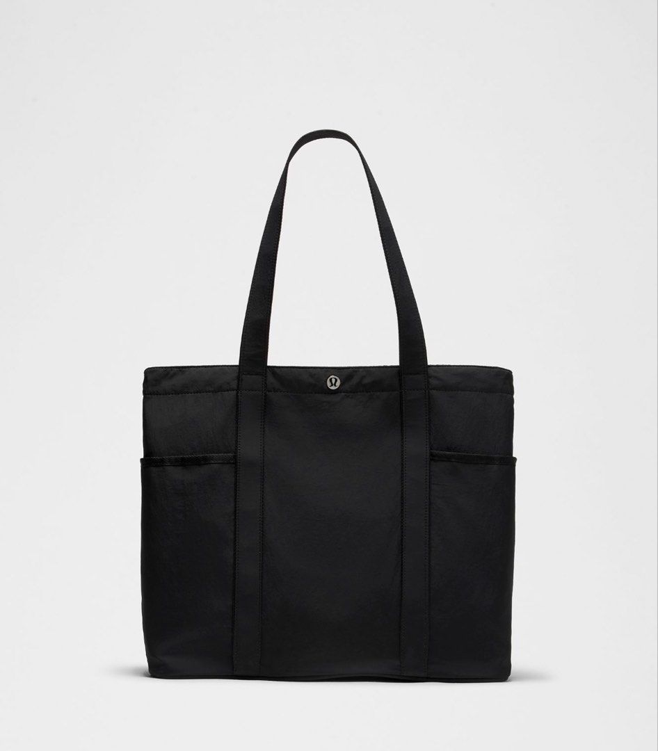 Lululemon Everyday Essentials Tote Bag 20L (Category: Tote Bags) located in Muntinlupa City. Submitted by peachonlineshop (Listing ID 1467302218, Image 3). Description: - Brand: Lululemon - Color: Soft pastel pink - Style: Everyday tote bag with dual shoulder straps - Features: Exterior side pockets and secure snap button closure - Capacity: Spacious interior, ideal for daily essentials, gym gear, or work items.