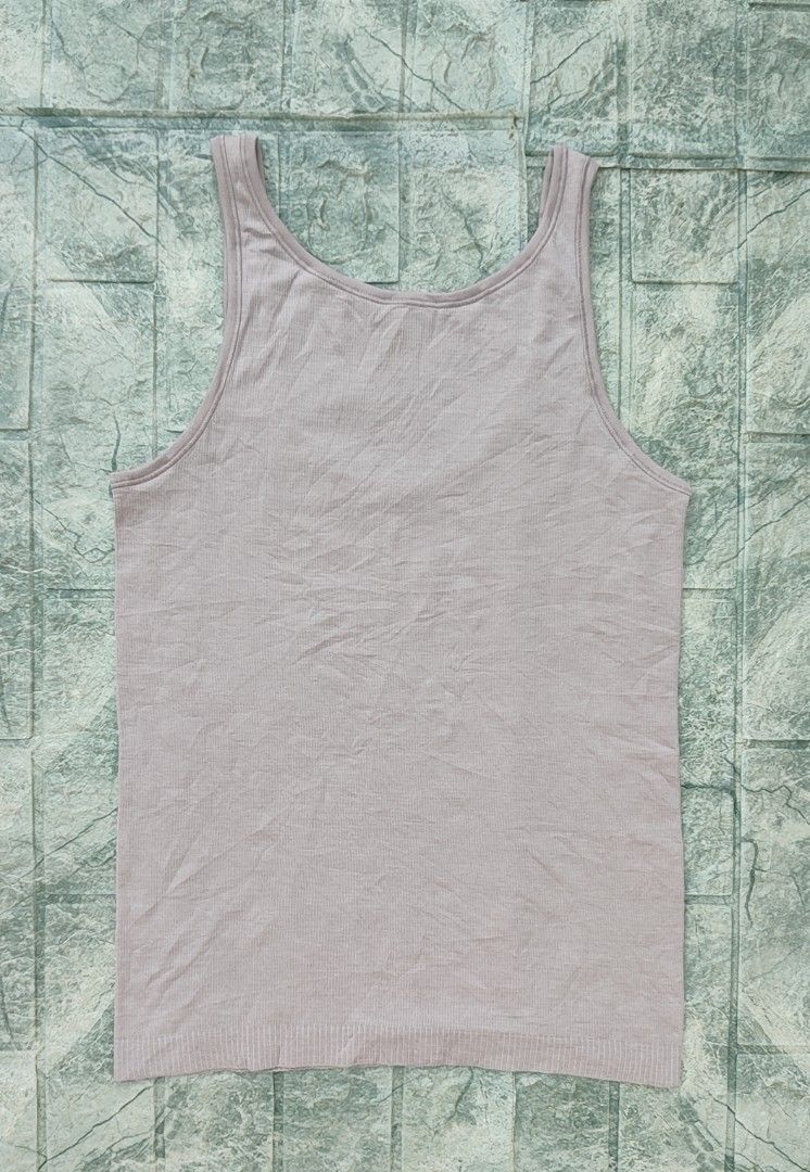 Lululemon Seek Simplicity Tank top (Category: Sleeveless) located in Bayambang. Submitted by mon10192816 (Listing ID 1467257817, Image 2). Description: - Width 15 - Length 24 - Brand: Lululemon - Texture: Ribbed knit with small reflective omega logo on lower left hem - Fit & Fabric: Standard fit, breathable, and stretchable - Condition: Excellent for workouts or casual daily wear.