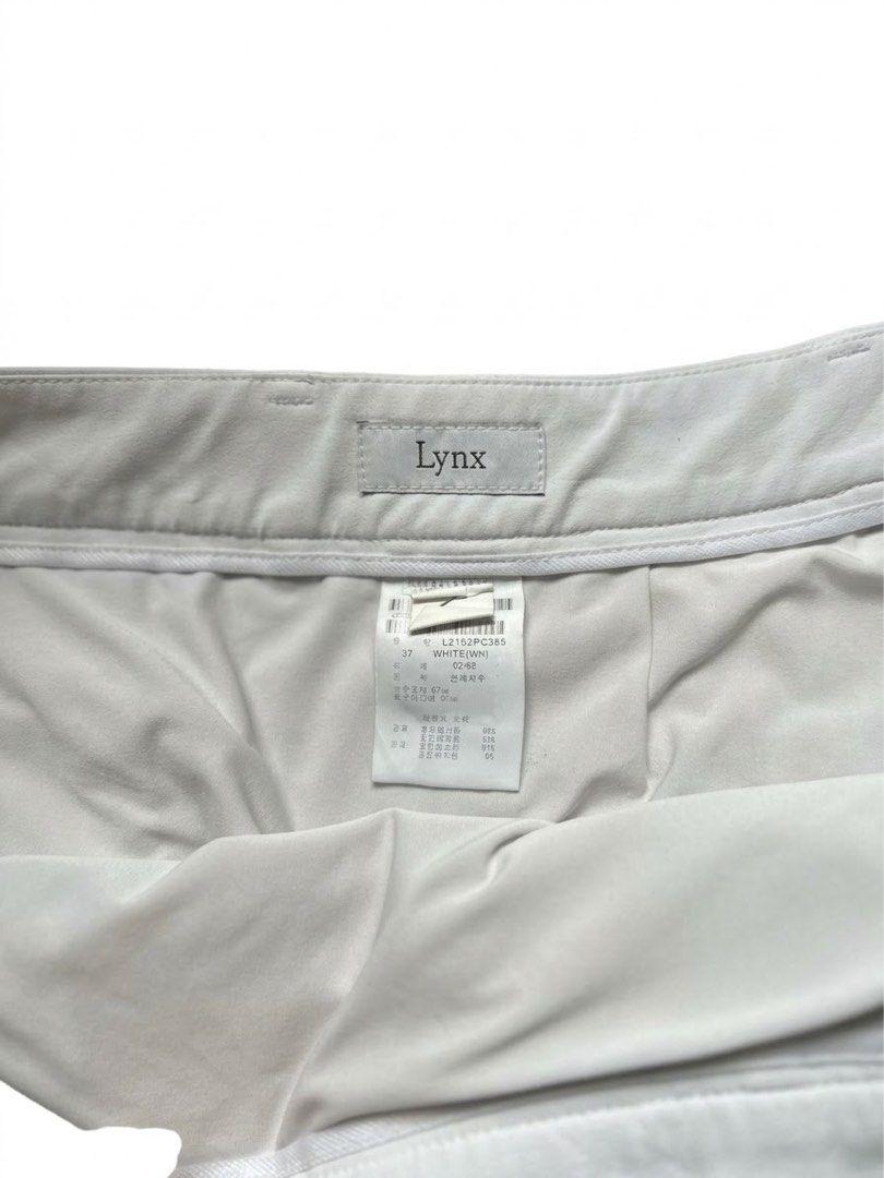Lynx White Athletic Golf Skort (Category: Skirts) located in Davao. Submitted by rummagingmymomscloset (Listing ID 1467208241, Image 3). Description: - Brand: Lynx - Item: Golf Skort - Color: Clean White - Style Code: L2152PC385 - Size: 68 (inner tag) - Features: Belt loops, side tab button closure, front pockets, and a stylish striped slit detail - Material: Lightweight athletic fabric, perfect for the golf course or the pickleball court..