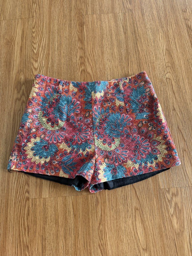 Mags Floral Lace Pattern Shorts Size L (Category: Shorts) located in Quezon City. Submitted by morgan_rysblk (Listing ID 1467182787, Image 1). Description: - Size: L - Design: Colorful floral lace pattern in shades of pink, blue, and yellow with a black lining - Fit: Mid-rise waist with a structured fit - Perfect for: Summer weather, music festivals, or casual daytime outings - Fits size 25 waistline.