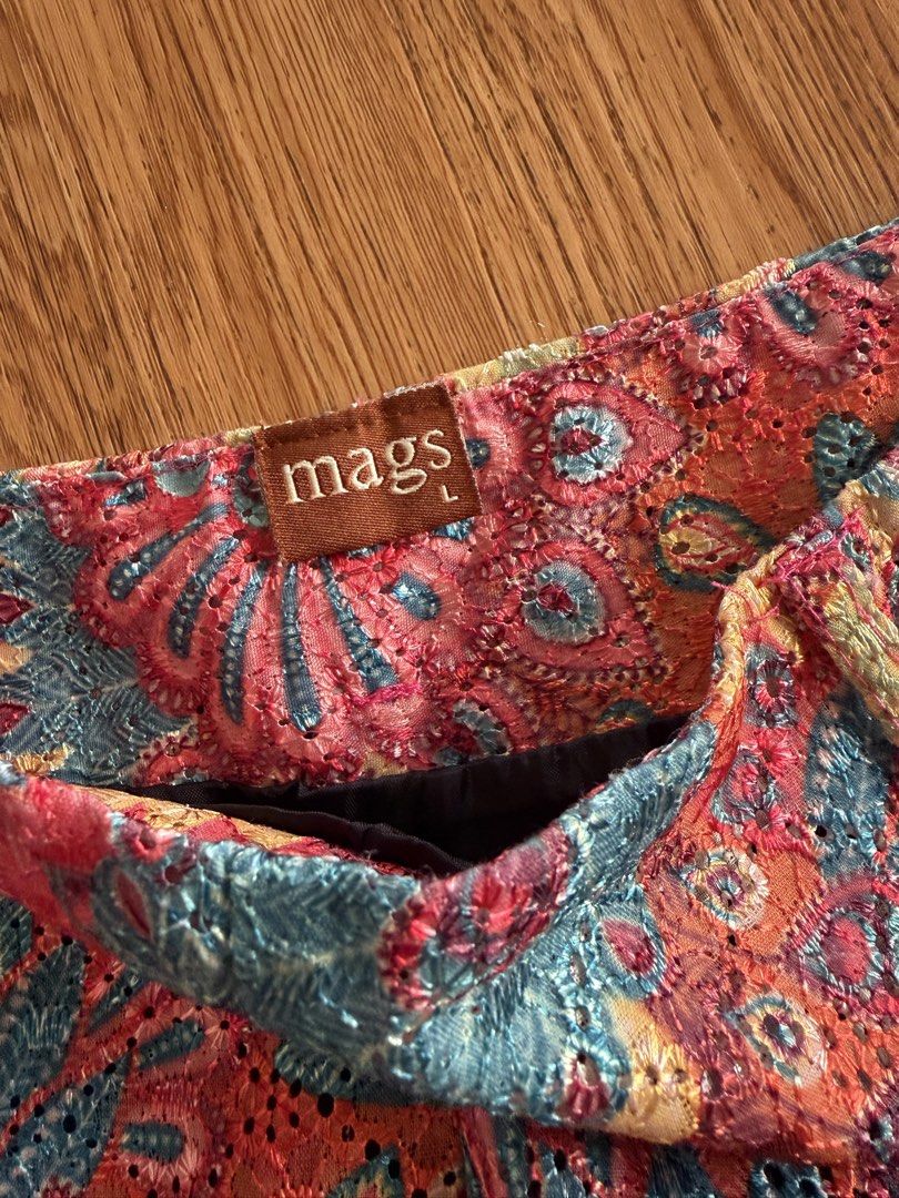 Mags Floral Lace Pattern Shorts Size L (Category: Shorts) located in Quezon City. Submitted by morgan_rysblk (Listing ID 1467182787, Image 3). Description: - Size: L - Design: Colorful floral lace pattern in shades of pink, blue, and yellow with a black lining - Fit: Mid-rise waist with a structured fit - Perfect for: Summer weather, music festivals, or casual daytime outings - Fits size 25 waistline.
