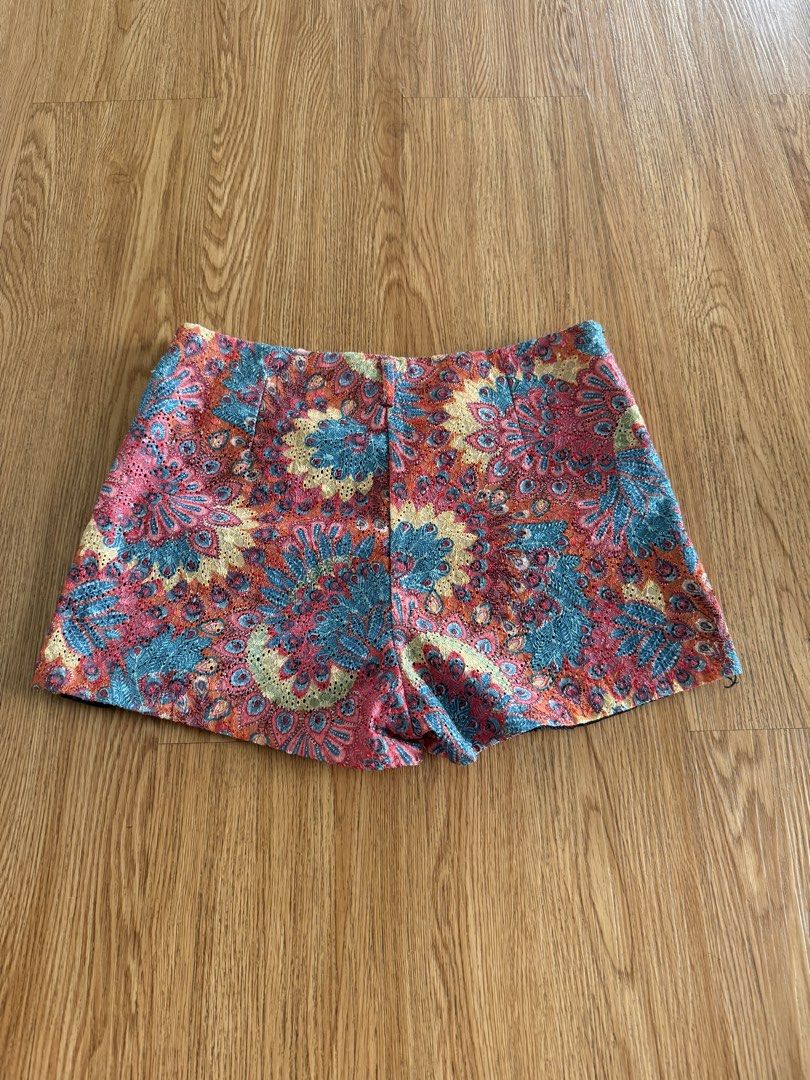 Mags Floral Lace Pattern Shorts Size L (Category: Shorts) located in Quezon City. Submitted by morgan_rysblk (Listing ID 1467182787, Image 2). Description: - Size: L - Design: Colorful floral lace pattern in shades of pink, blue, and yellow with a black lining - Fit: Mid-rise waist with a structured fit - Perfect for: Summer weather, music festivals, or casual daytime outings - Fits size 25 waistline.