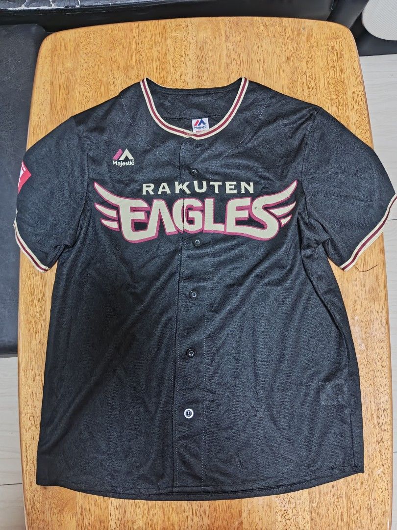 Majestic Athletic Rakuten Eagles Baseball Jersey Medium (Category: Activewear) located in Manila. Submitted by charleshustla (Listing ID 1467213544, Image 1). Description: - Brand: Majestic Athletic - Team: Rakuten Eagles - Size: Medium - Color: Black with cream and maroon accents - Design: Button-down front closure with clear chest graphics and brand logo on the right sleeve - Condition: Clean fabric throughout, well-maintained.