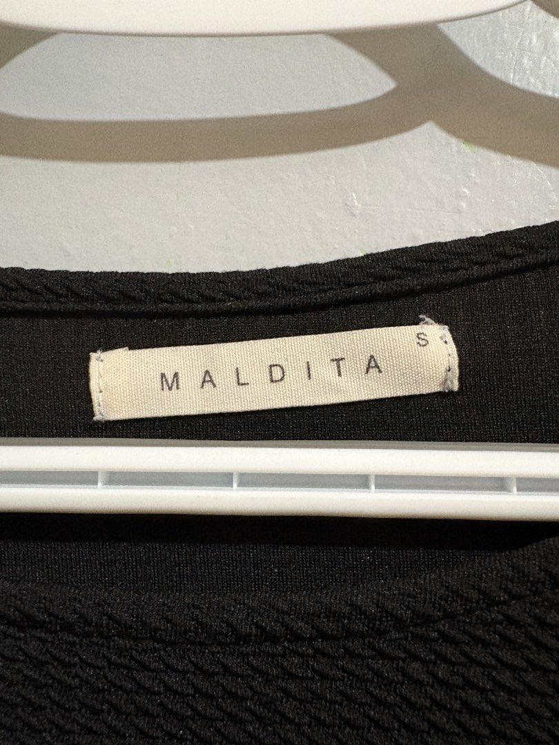 Maldita Black Textured Top Size S (Category: Blouses) located in Manila. Submitted by margascloset_ (Listing ID 1467299797, Image 3). Description: Maldita Black Small Blouse - can fit up to small-medium - Style: Short sleeves, round neckline, curved hemline - Fabric: Textured waffle-like material - Condition: Clean, no flaws .