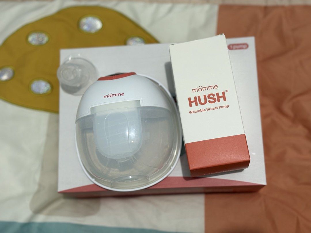 Mamme HUSH Wearable Breast Pump (Category: Breastfeeding & Bottle Feeding) located in Manila. Submitted by crissylunaria (Listing ID 1467356220, Image 1). Description: - Mamme Hush wearable breast pump system complete set w/ manual - Wireless design fits right inside your bra - Allows easy, hands-free pumping while moving around - Includes main motor unit, clear milk collection cup, and funnel attachments - Comes with original packaging box - Cle