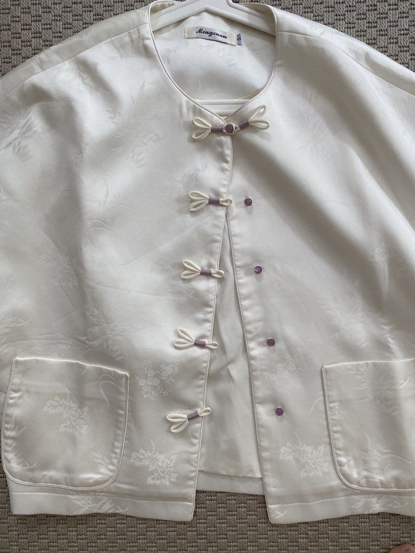Mandarin / Chinese Collar Jacket (Category: Coats, Jackets and Outerwear) located in Pasig City. Submitted by misscsj (Listing ID 1467189837, Image 2). Description: - Brand/Style: Mingxuan silk blouse - Color: Off-white with floral jacquard pattern - Details: Traditional front frog closures with purple accents and matching purple sleeve cuffs - Features: Two convenient front patch pockets - Size: S (tag at collar) - Occasion: Great for cultural e