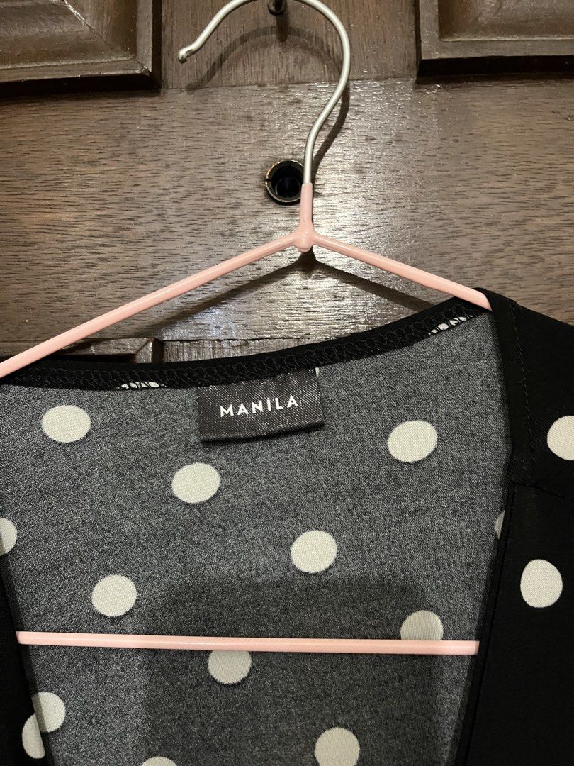 Manila Black and White Polka Dot Wrap Blouse (Category: Blouses) located in Makati City. Submitted by yoursecondbest (Listing ID 1467256322, Image 2). Description: - Color: Black with white polka dots - Brand: Manila - Style: Wrap top with adjustable waist tie - Neckline: V-neck - Sleeves: Half sleeves - Material: Lightweight and comfortable - Versatile casual wear, easy to match with jeans or skirts.