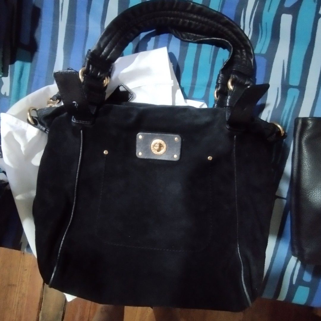 Marc by Marc Jacobs Black Suede Handbag (Category: Cross-body Bags) located in Manila. Submitted by lene48 (Listing ID 1467278967, Image 3). Description: - Brand: Marc by Marc Jacobs - Material: Premium black suede with gold-tone hardware - Closure: Secure turnlock plate on the front exterior pocket - Carrying Options: Dual top handles and a detachable shoulder strap - Interior: Stylish black and white patterned fabric lining with a convenient zi