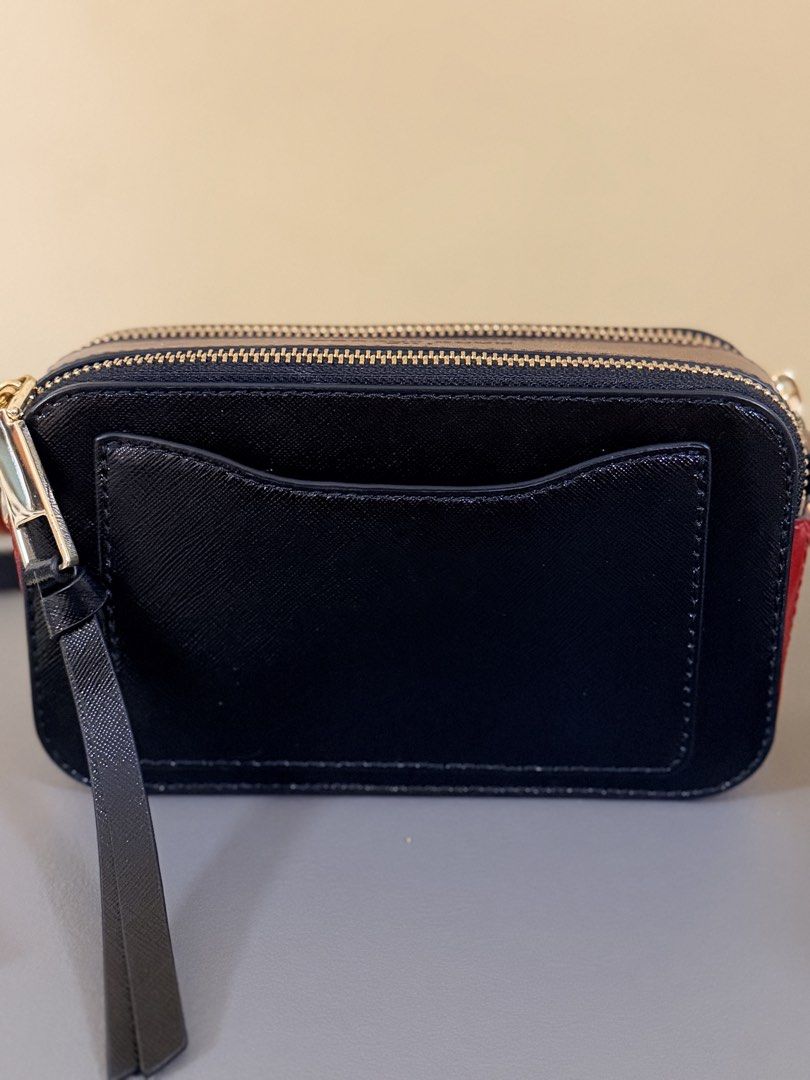 Marc Jacobs Snapshot Camera Bag (Category: Luxury Bags & Wallets) located in Pasig City. Submitted by stuffrightnow (Listing ID 1467238313, Image 3). Description: - Authentic Marc Jacobs Snapshot camera bag - Stunning black, burgundy, and red colorblock design with gold-tone hardware - Classic interlocking J logo on the front - Double zipped compartments for easy organization - Clean leather finish with a well-maintained structured shape - Includ