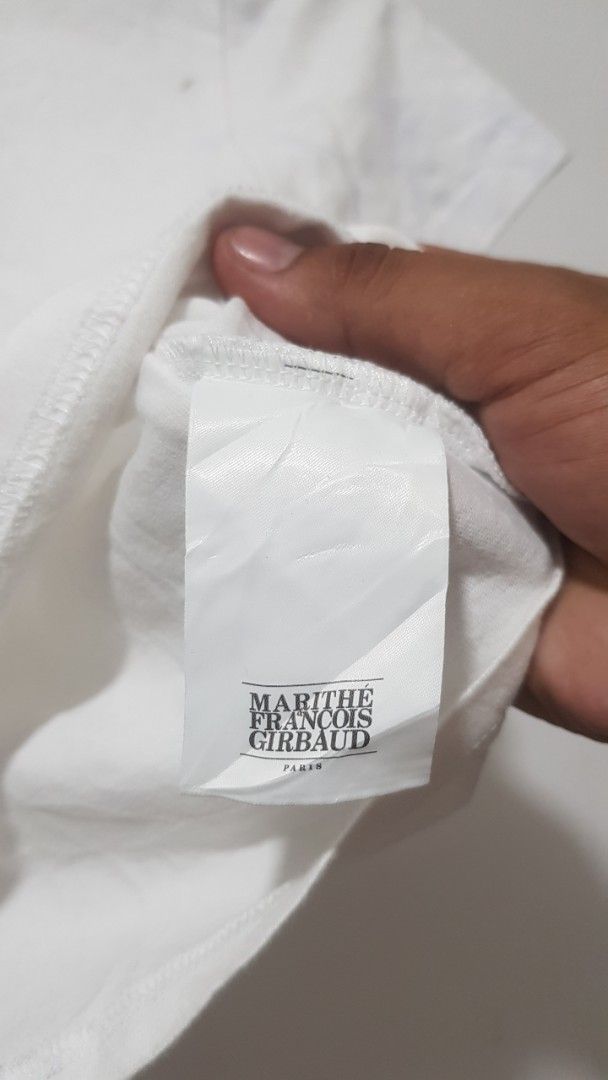 Marithe Francois Girbaud Paris White T-Shirt Size S (Category: Shirts) located in Manila. Submitted by nice430 (Listing ID 1467295948, Image 3). Description: - Brand: Marithé François Girbaud - Color: Clean White with Bold Black Box Logo - Size: S (Best fit for height: 155-160cm, Bust: 80-86cm) - Material: 100% Premium Cotton - Design: Classic crew neck, short sleeves - Condition: Brand new with interior brand tags and care label - Style: Versati